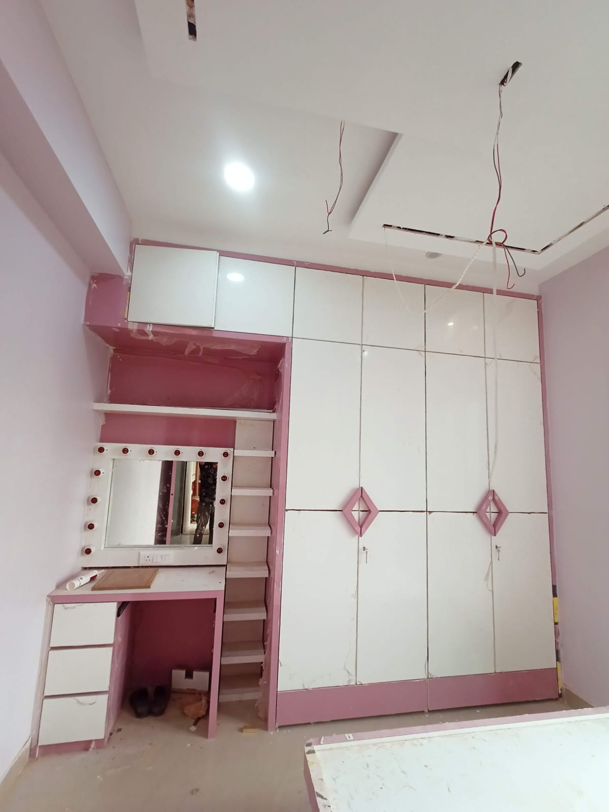 Pink and white bedroom wardrobe with dressing table